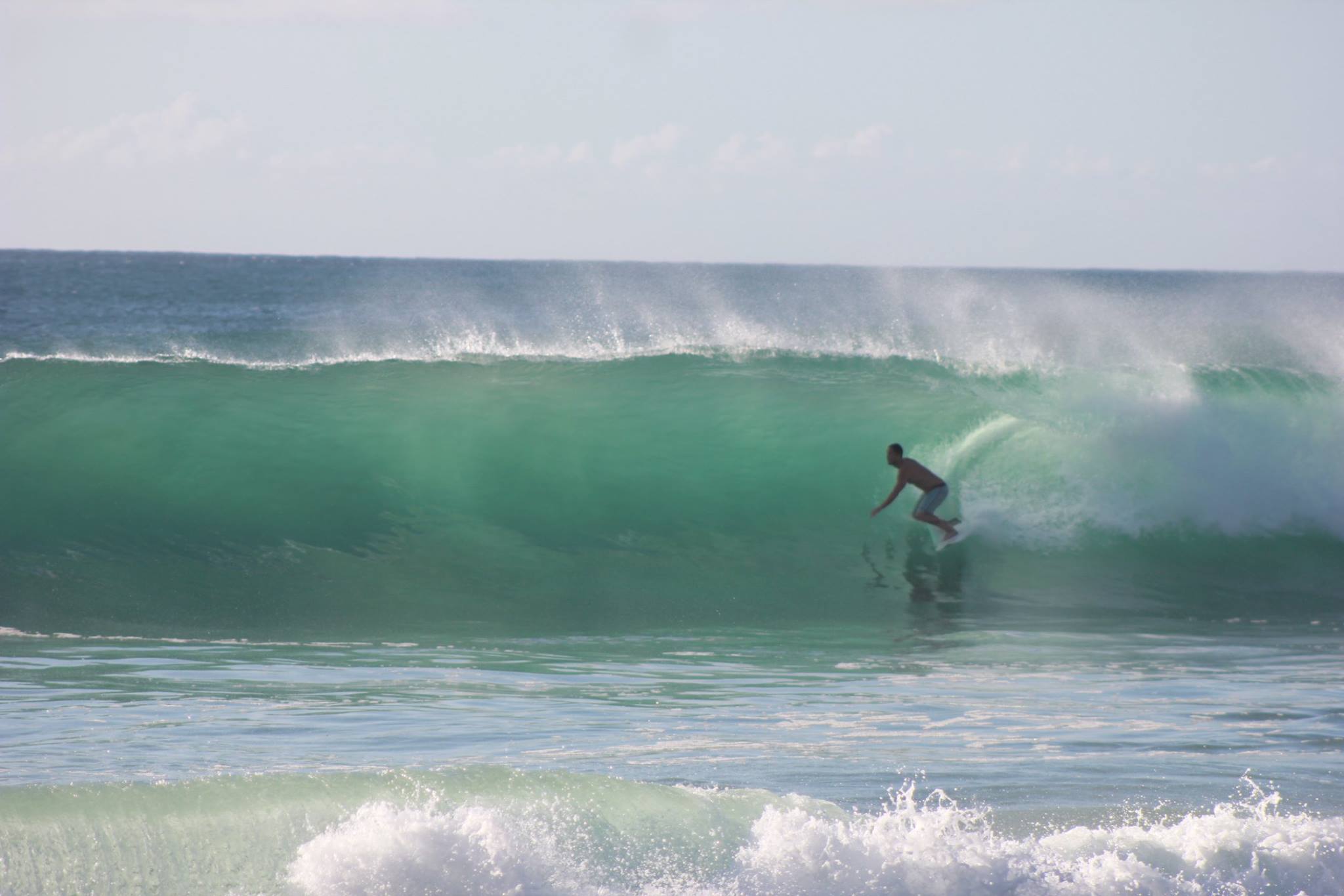 Person surfing an ocean wave